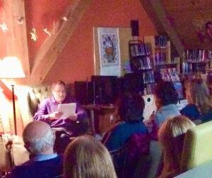 man reading to an adult audience