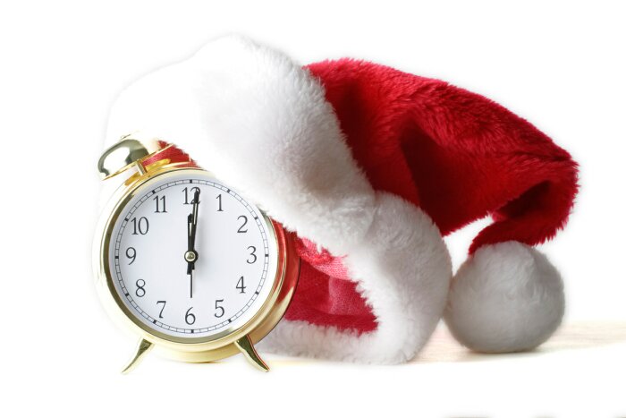 clock with a Santa hat on it to indicate holiday hours