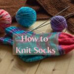 socks with yarn and knitting needles